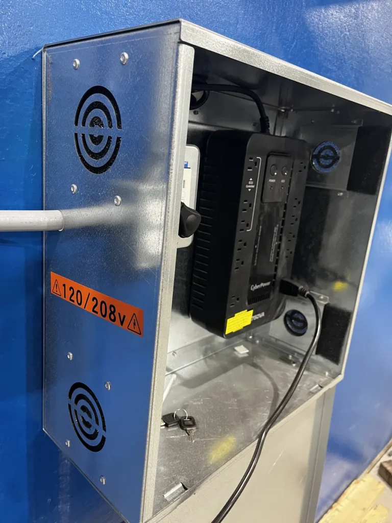 Angled open prototype enclosure showing ventilation openings and electrical components